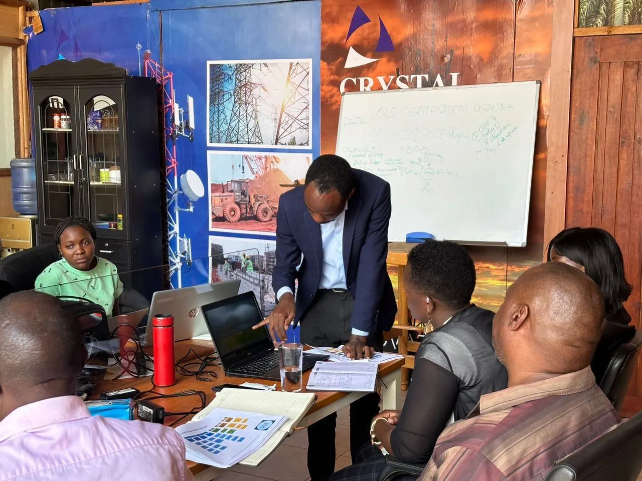 ISO Lead Auditor training session in Uganda with professionals at laptops